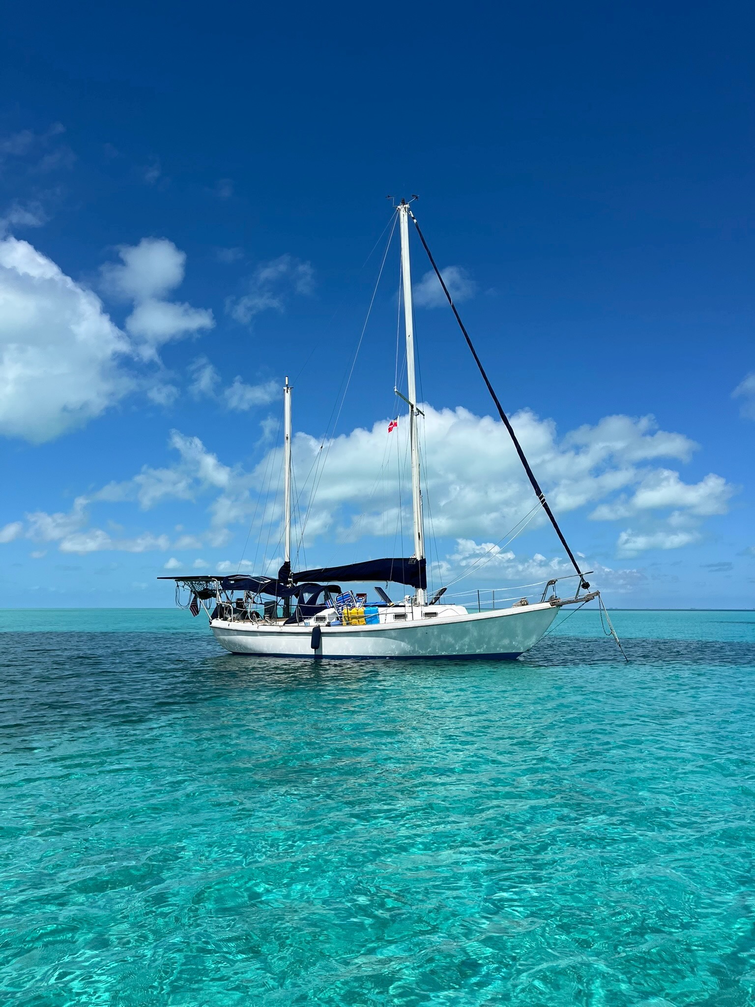 1979 Allied Seawind II at anchor in clear turquoise water, ketch rig profile